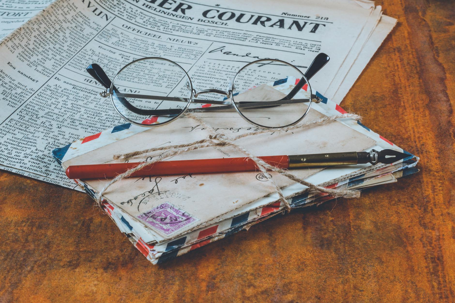 letters and an eyeglass on table