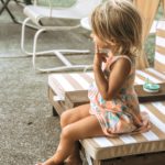 photo of kid sitting on a chair